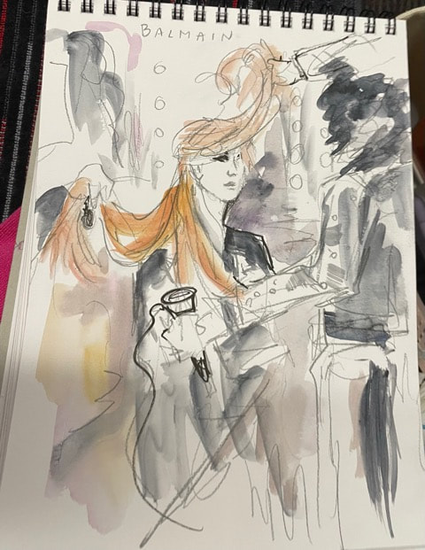 drawing in a sketchbook of backstage hair at a fashion show