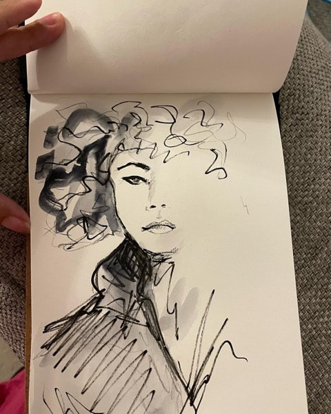 drawing of a face inside a sketch book